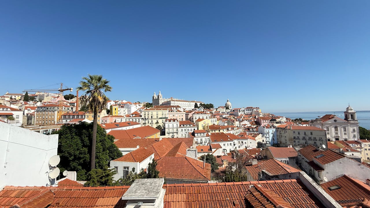 Mastering the First Impression: Your intriguing post title goes here Experience the vibrant landscape of Lisbon with its iconic red tiled rooftops under a clear blue sky.