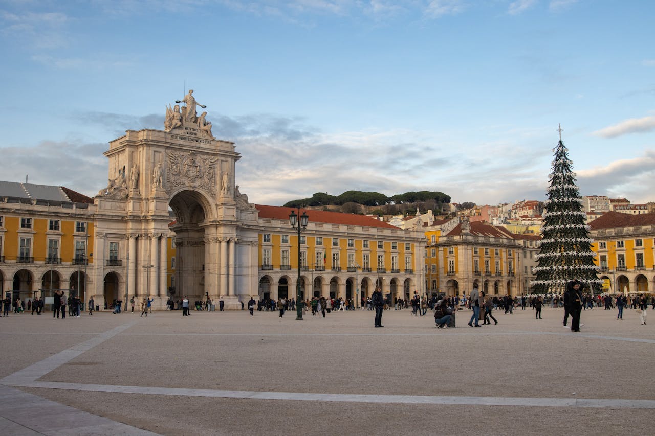 The Art of Drawing Readers In: Your attractive post title goes here View of Lisbon's iconic Praça do Comércio with a festive Christmas tree and Arc de Triomphe.