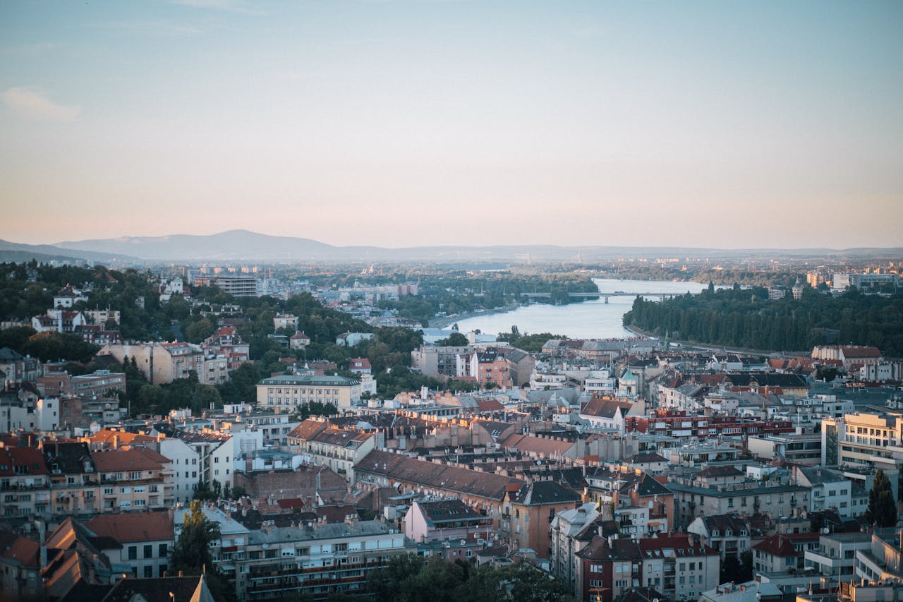 services-04 Aerial shot of Budapest with the Danube River and city architecture during sunset.